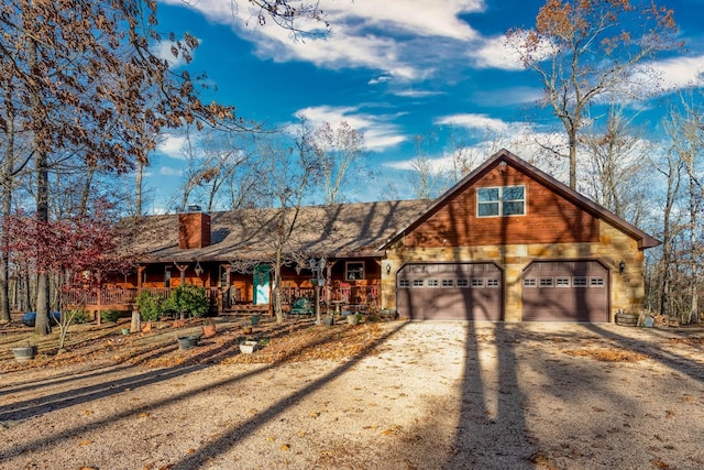 view of front of home featuring covered porch and a garage