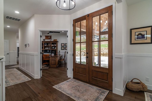 foyer entrance with french doors and dark hardwood / wood-style flooring