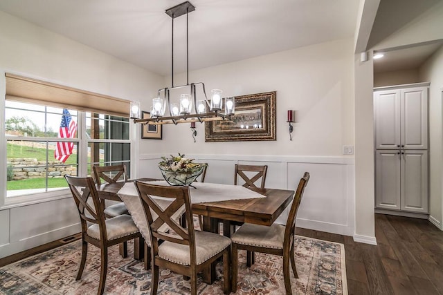 dining room featuring dark hardwood / wood-style floors and a notable chandelier