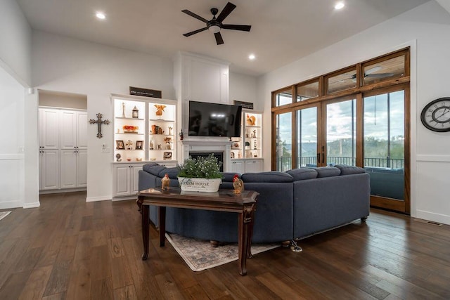 living room featuring ceiling fan, dark hardwood / wood-style flooring, and high vaulted ceiling