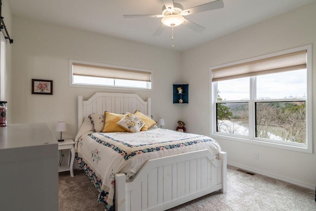 bedroom featuring light carpet and ceiling fan