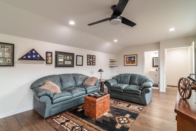 living room with hardwood / wood-style flooring, ceiling fan, and lofted ceiling