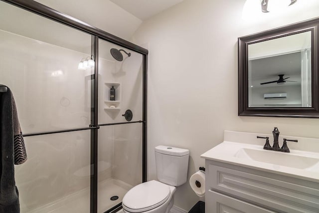 bathroom with ceiling fan, vanity, an enclosed shower, and toilet