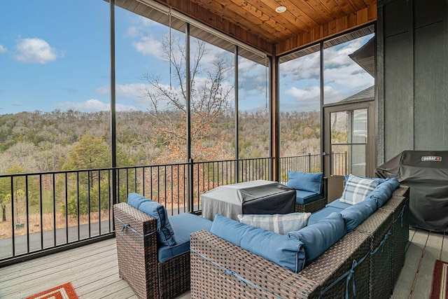 sunroom / solarium featuring plenty of natural light and wooden ceiling