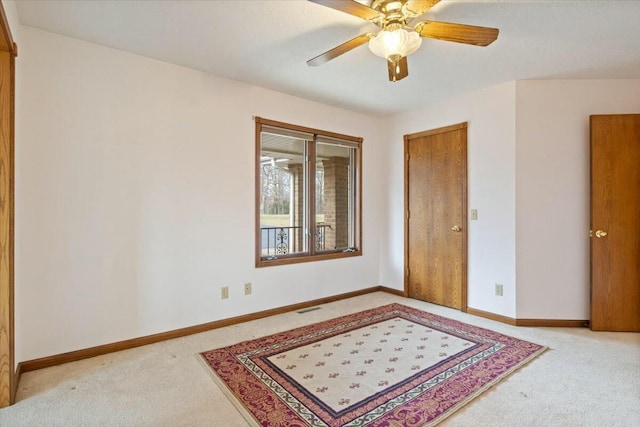 empty room featuring light carpet and ceiling fan