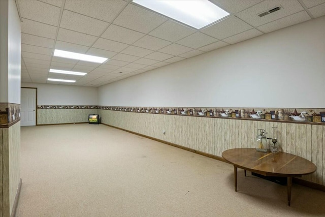 basement featuring carpet and a drop ceiling