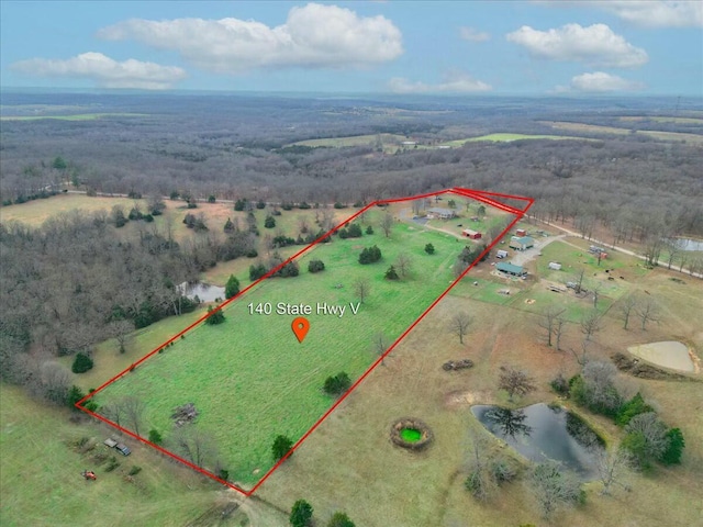 birds eye view of property featuring a rural view and a water view