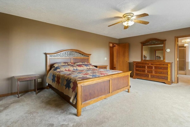 bedroom featuring carpet, ceiling fan, and a textured ceiling