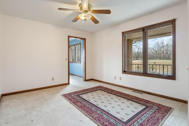 empty room with ceiling fan and light colored carpet