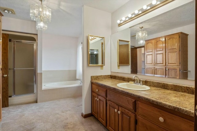 bathroom with vanity, independent shower and bath, a textured ceiling, and an inviting chandelier