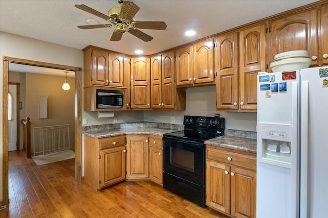 kitchen with ceiling fan, white fridge with ice dispenser, light hardwood / wood-style flooring, and black / electric stove