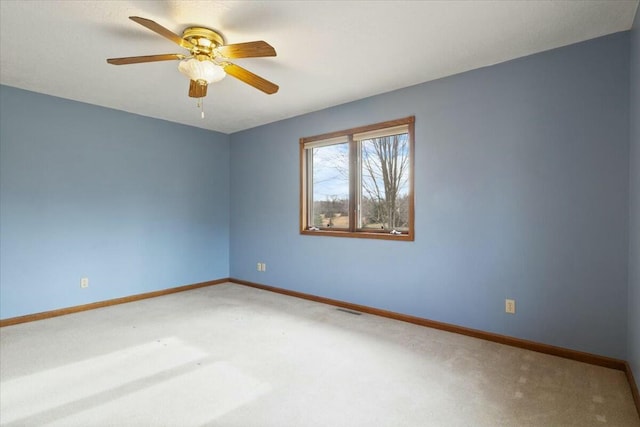 carpeted empty room featuring ceiling fan