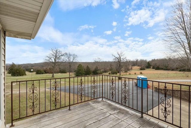 deck with a rural view, area for grilling, and a lawn