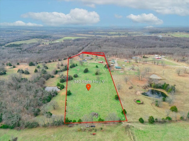 birds eye view of property with a rural view