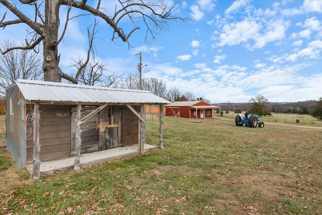 view of yard featuring an outbuilding and a rural view