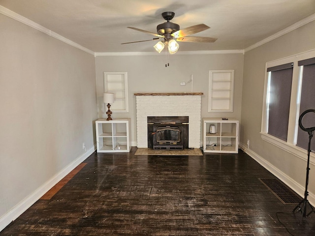 unfurnished living room featuring a wood stove, ceiling fan, built in shelves, crown molding, and hardwood / wood-style flooring