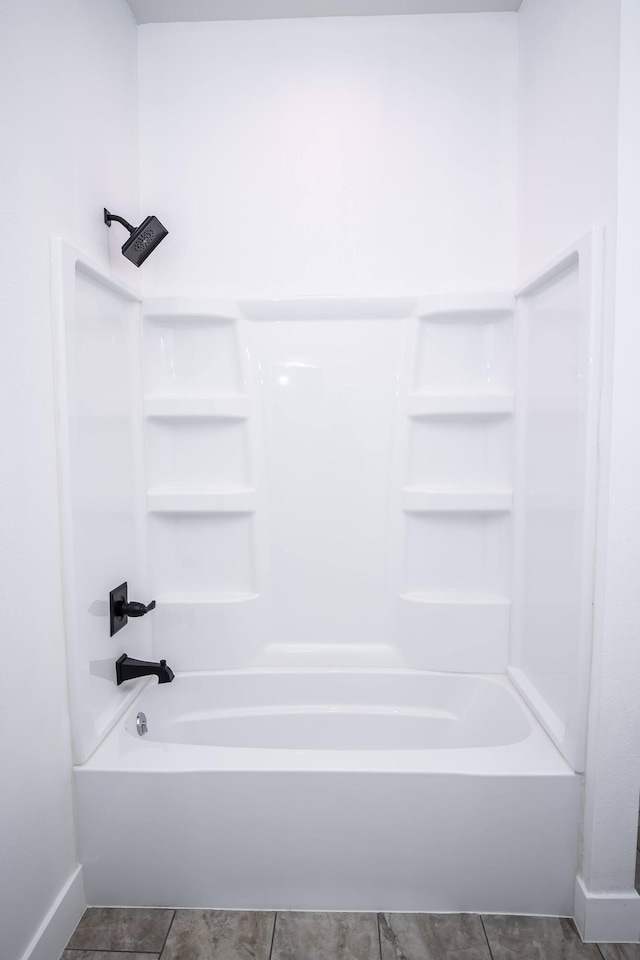 bathroom featuring tile patterned flooring and shower / bathtub combination