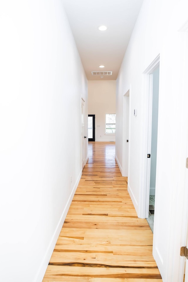 corridor with light wood-type flooring