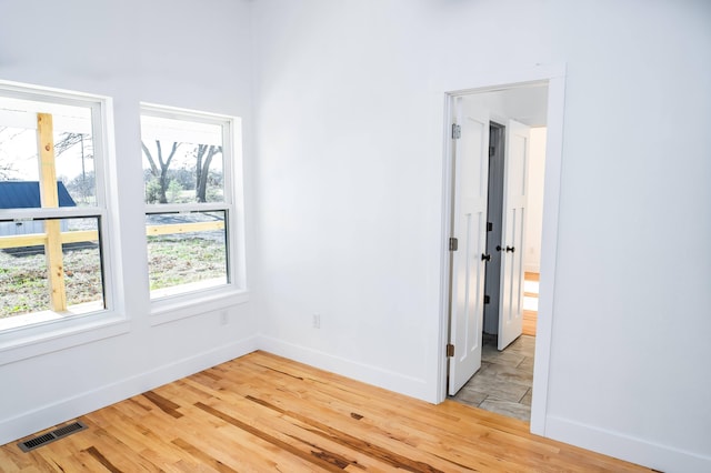 unfurnished room featuring light wood-type flooring