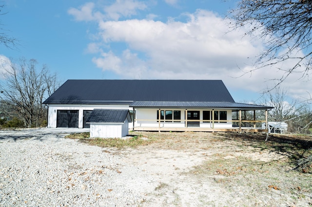 view of front facade featuring covered porch and an outdoor structure