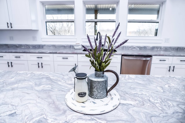 kitchen with white cabinets, stainless steel dishwasher, and sink