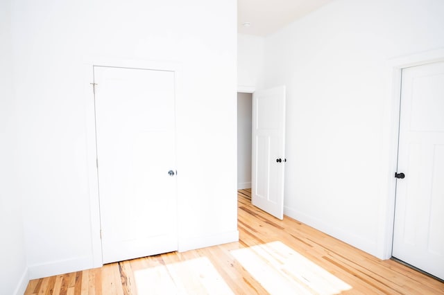 unfurnished bedroom featuring light hardwood / wood-style flooring and a closet