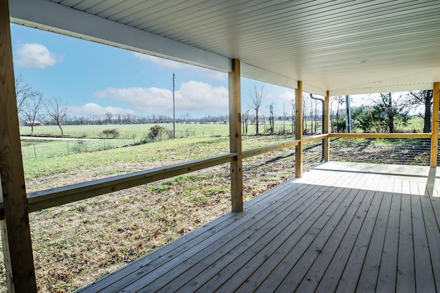 wooden deck with a rural view