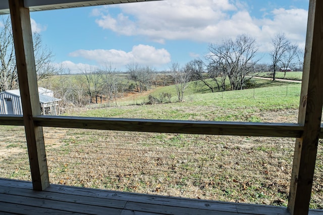 view of yard with a rural view and a balcony