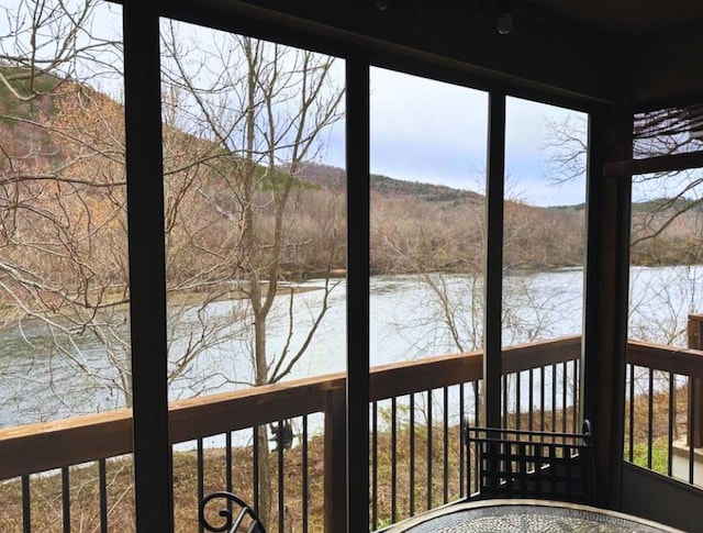 366 Wimbledon Dr Unit 10, Branson, MO 65616 - unfurnished sunroom with a water view