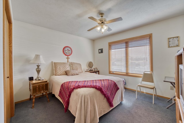 carpeted bedroom featuring ceiling fan and a textured ceiling