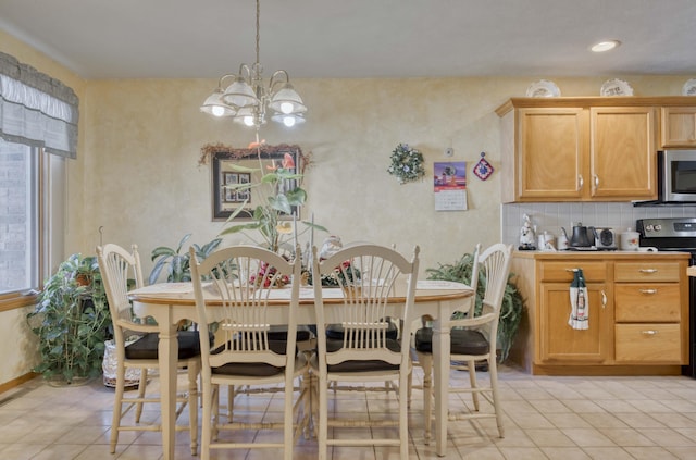 tiled dining room featuring an inviting chandelier