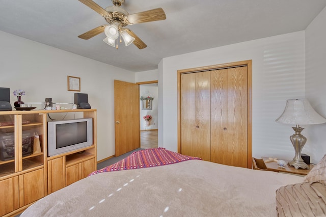 bedroom with ceiling fan, carpet floors, and a closet