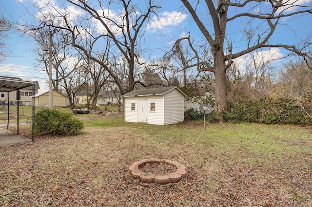 view of yard featuring a fire pit and a storage unit