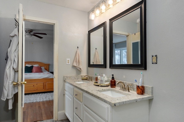 bathroom featuring hardwood / wood-style floors, ceiling fan, and vanity