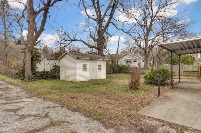 view of yard featuring a carport and a storage shed