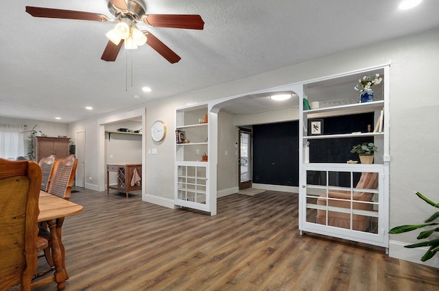 interior space with a textured ceiling, dark hardwood / wood-style floors, and ceiling fan