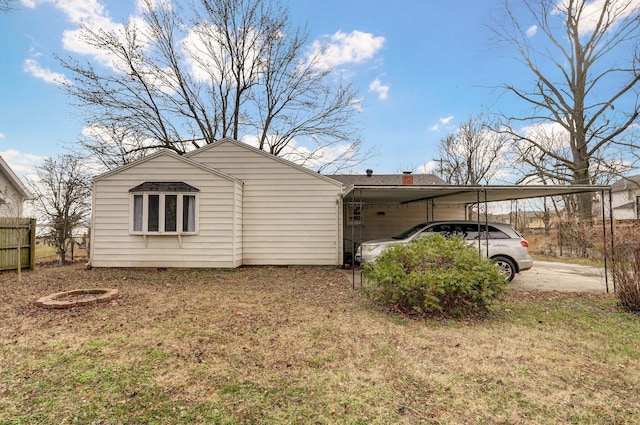 view of side of home with a carport and a yard