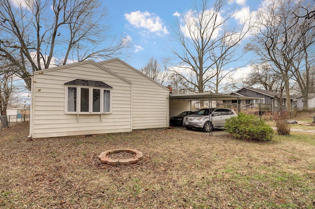 view of side of home with a yard and a carport