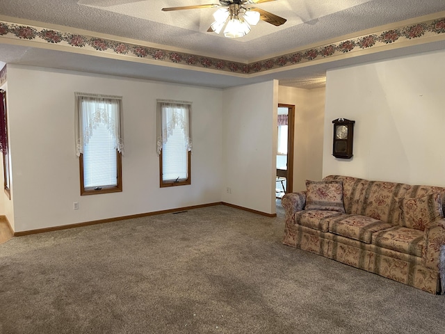 carpeted living room with a textured ceiling and ceiling fan