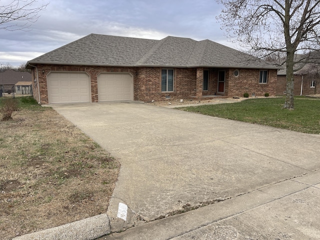 single story home featuring a garage and a front lawn