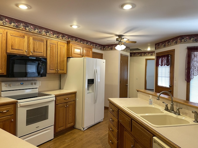 kitchen featuring ceiling fan, sink, tasteful backsplash, light hardwood / wood-style floors, and white appliances