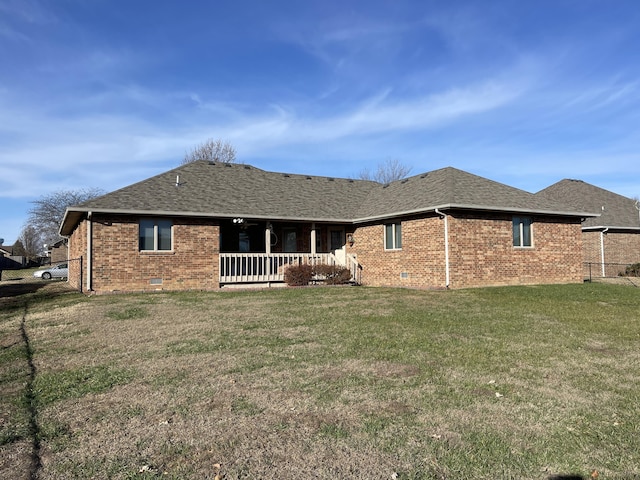 back of property with a porch and a yard