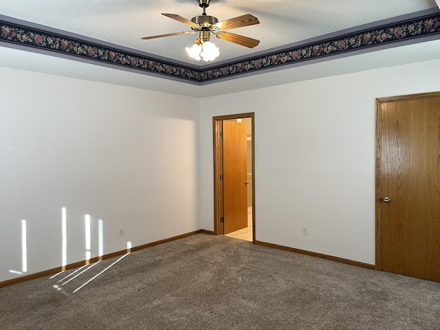 unfurnished room with carpet, a textured ceiling, and ceiling fan