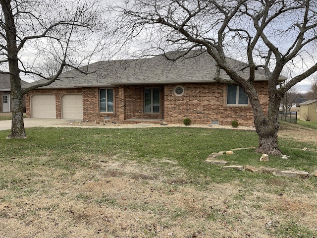 ranch-style home with a front yard and a garage