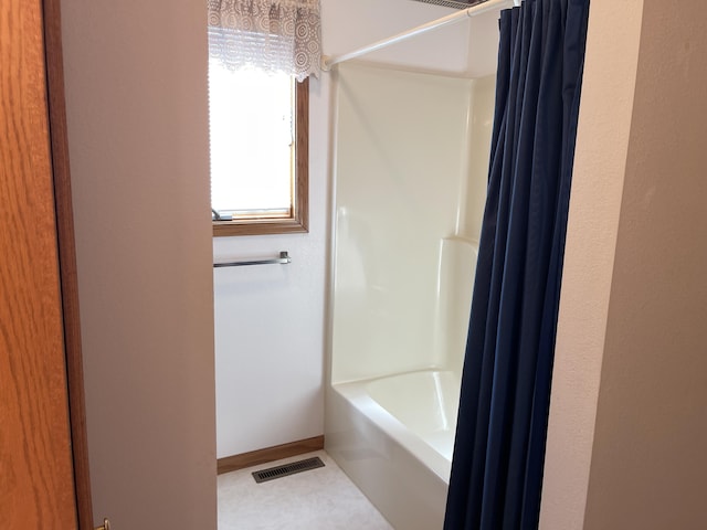 bathroom featuring tile patterned floors and shower / tub combo