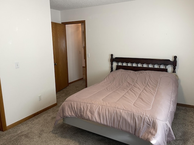 bedroom with a textured ceiling and carpet floors