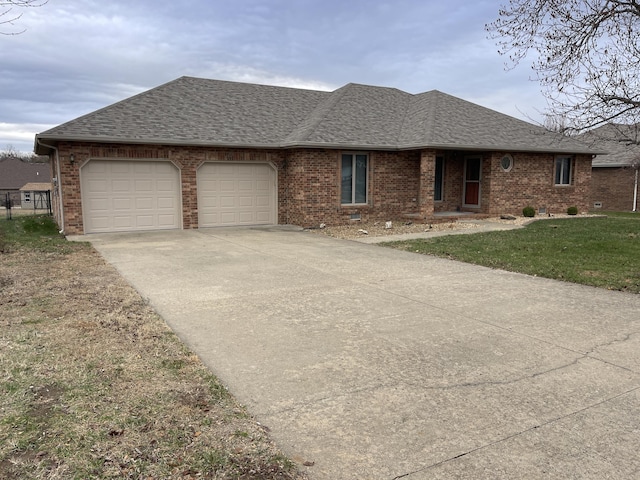 single story home with a garage and a front lawn