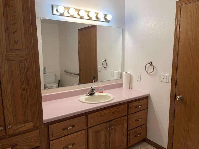 bathroom featuring vanity and toilet