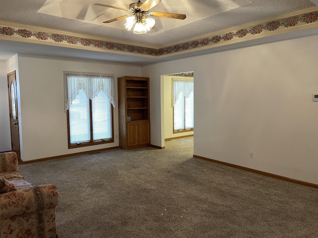 spare room featuring a wealth of natural light, ceiling fan, and a textured ceiling