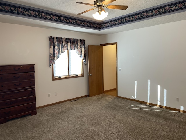 unfurnished bedroom featuring carpet flooring, ceiling fan, and a textured ceiling